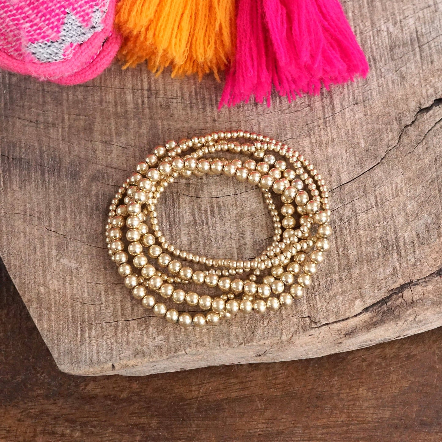 Multi size beaded bracelet stack 6 bracelets- worn gold tone
