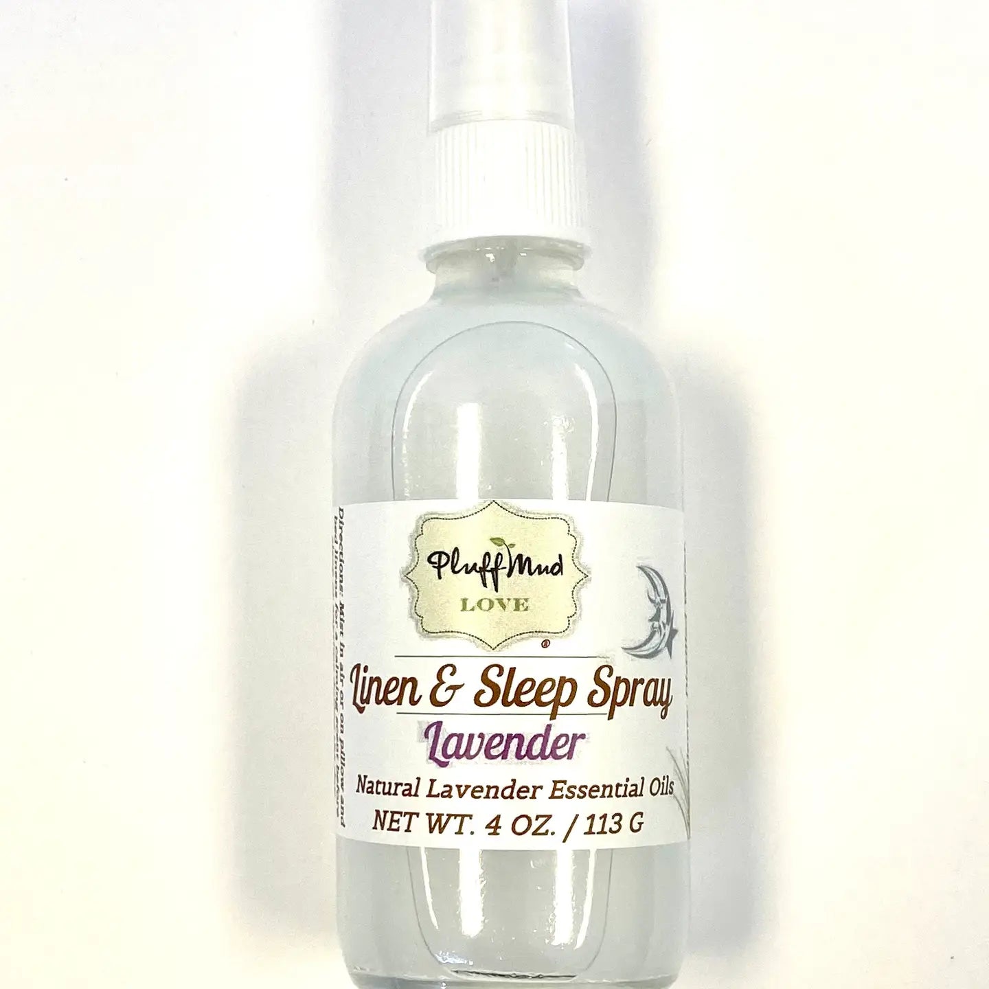 A clear spray bottle labeled 'Linen & Sleep Spray' with lavender color liquid visible inside. Locally made in Charleston,SC