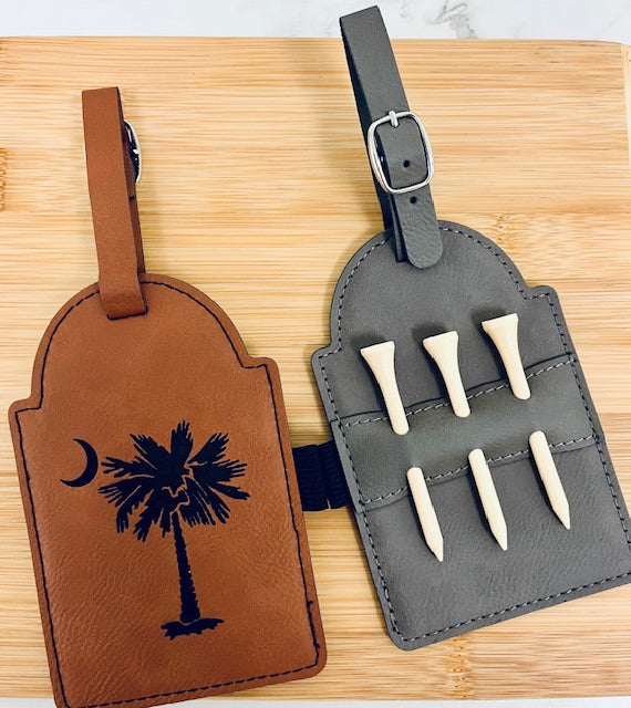 Tee off in style with this engraved faux leather golf bag tag — a sleek blend of function and personalization. Includes a set of 3 wooden tees and a durable strap to easily attach to any golf bag.
Whether it’s for a tournament favor, groomsmen gift, or just to elevate your own gear, this tag adds a touch of class to every round. Locally made in Charleston, SC.