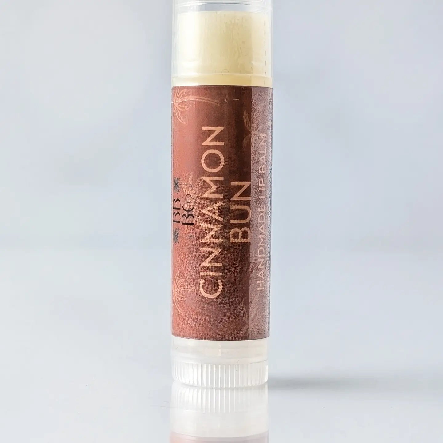 Lip balm with 'Cinnamon Bun' flavor on a natural and organic