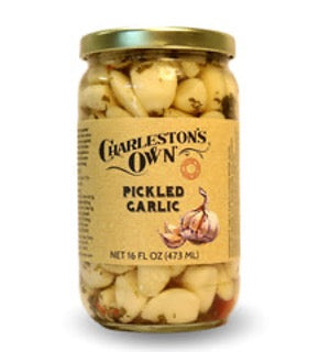 A jar of Charleston's Own Pickled Garlic, showing whole garlic cloves in a pickling solution with parsley and red pepper. Locally made in Charleston