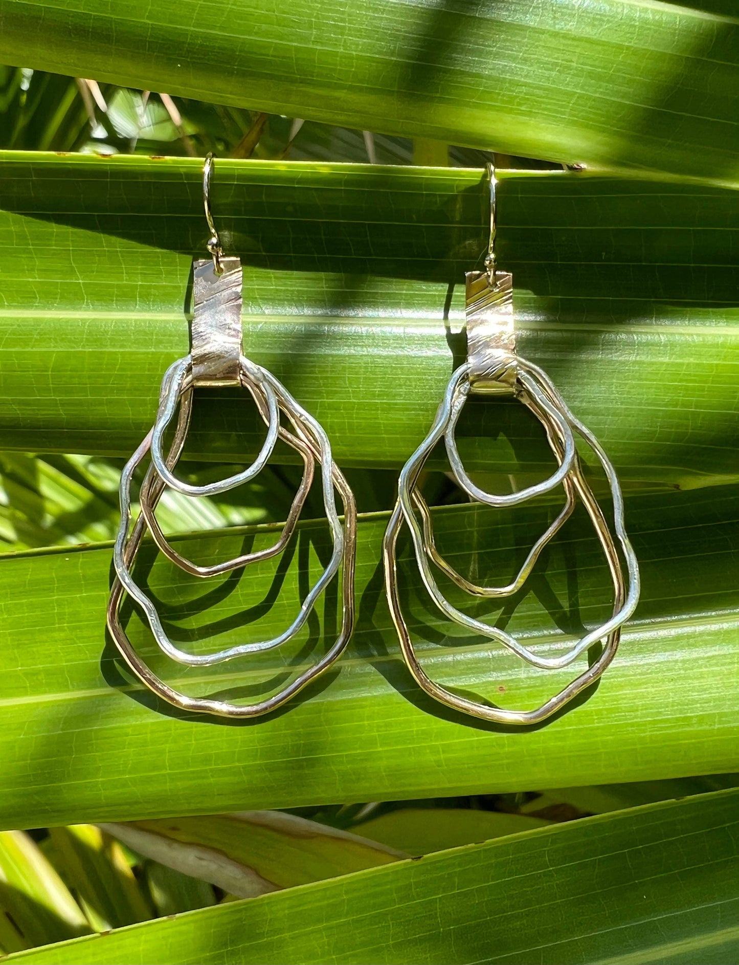 Silver and gold earrings.  Locally made in Charleston, South Carolina.  Handmade, wire oyster shape.