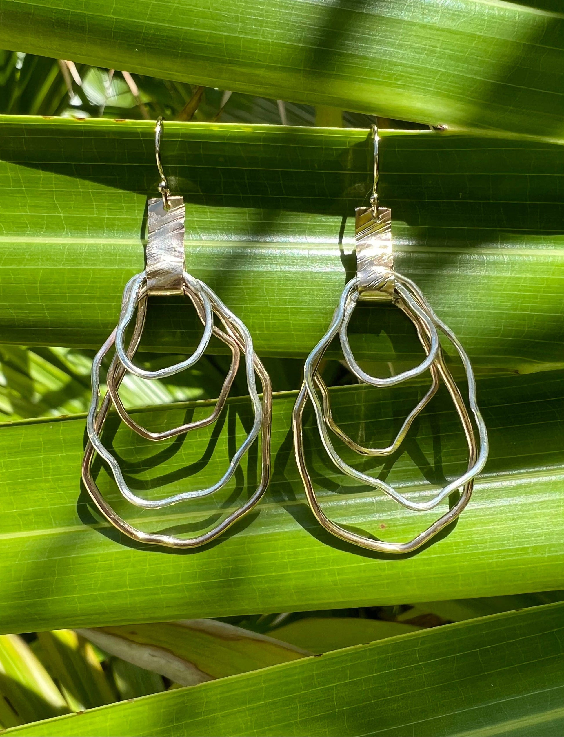 Silver and gold earrings.  Locally made in Charleston, South Carolina.  Handmade, wire oyster shape.