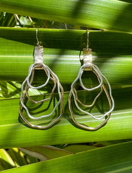 Silver and gold earrings.  Locally made in Charleston, South Carolina.  Handmade, wire oyster shape.