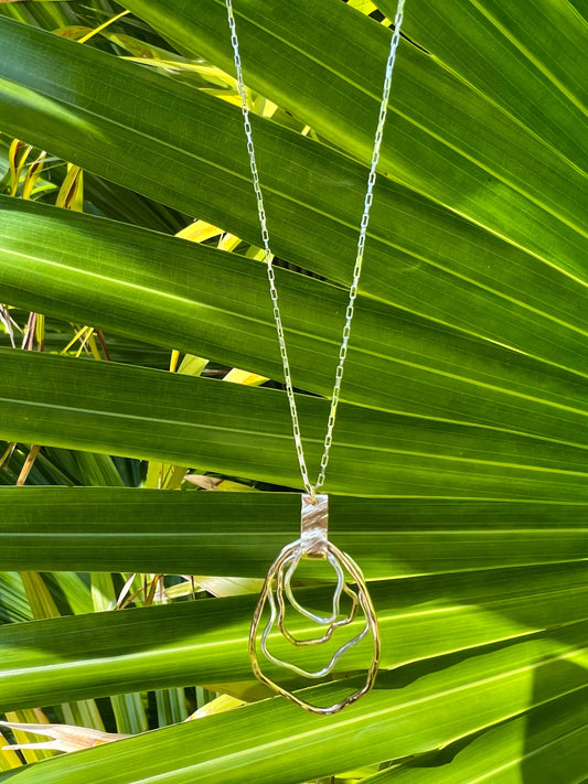 Gold and silver necklace with a wire oyster pendant locally made in Charleston, South Carolina.