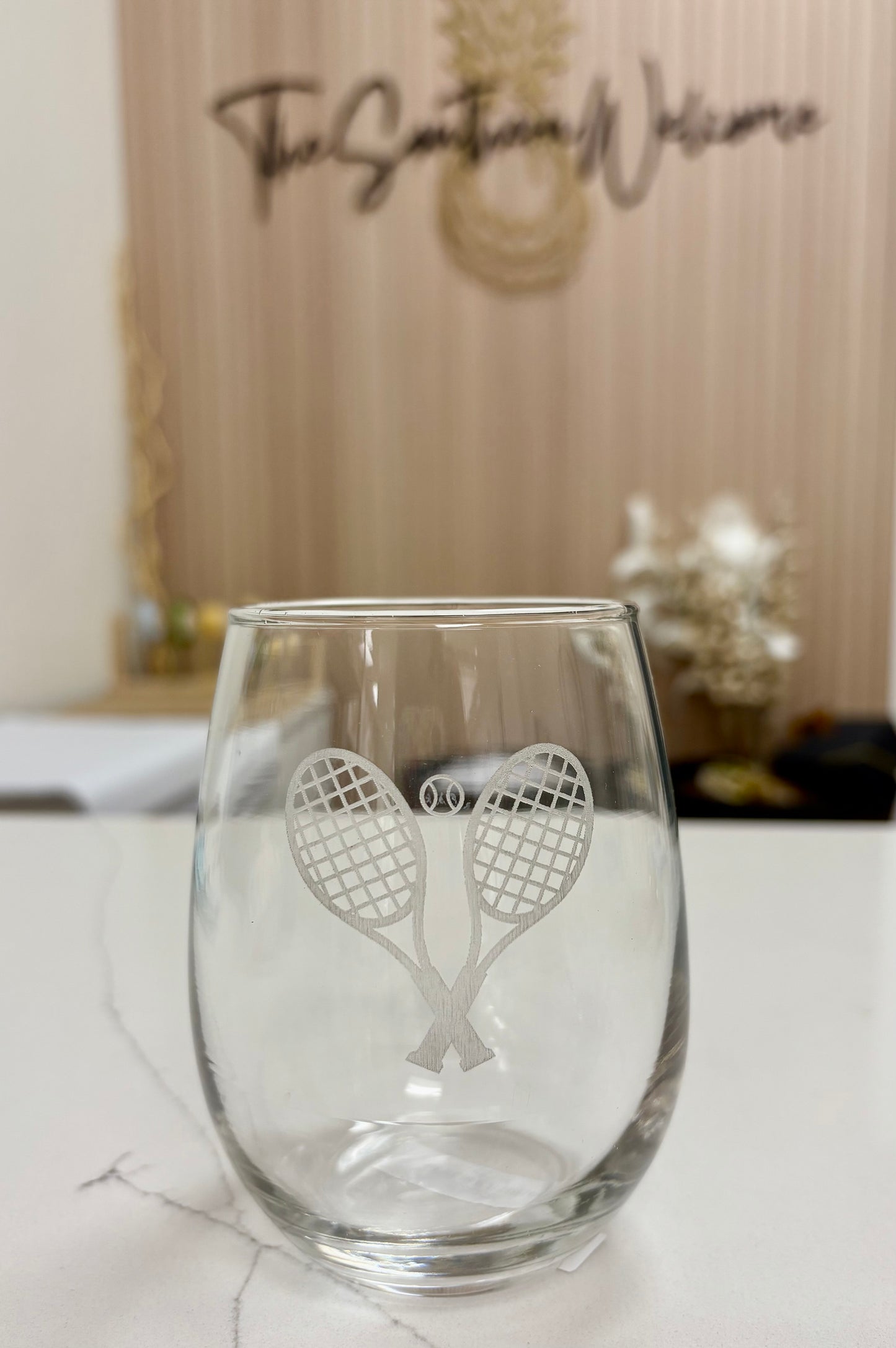 Locally made in Charleston Clear glass with tennis racket design on a white surface