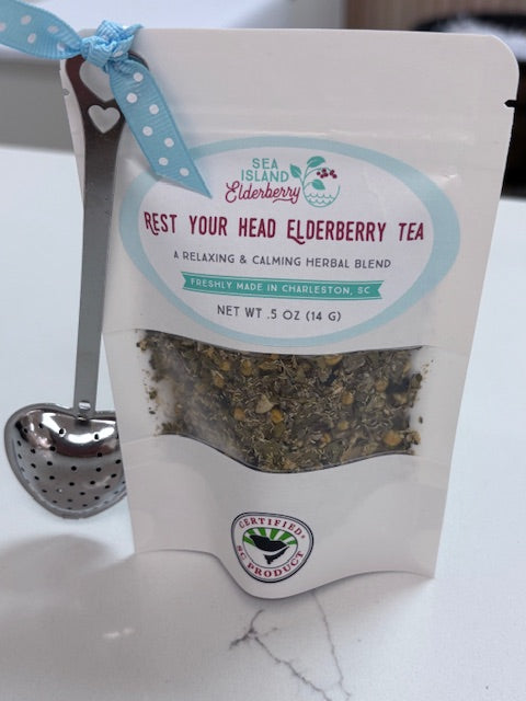 Sea Island Elderberry tea package with a silver tea infuser on a marble surface locally made in Charleston SC