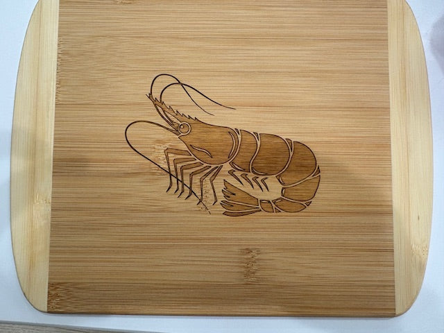 Wooden bamboo cutting board with a shrimp engraving