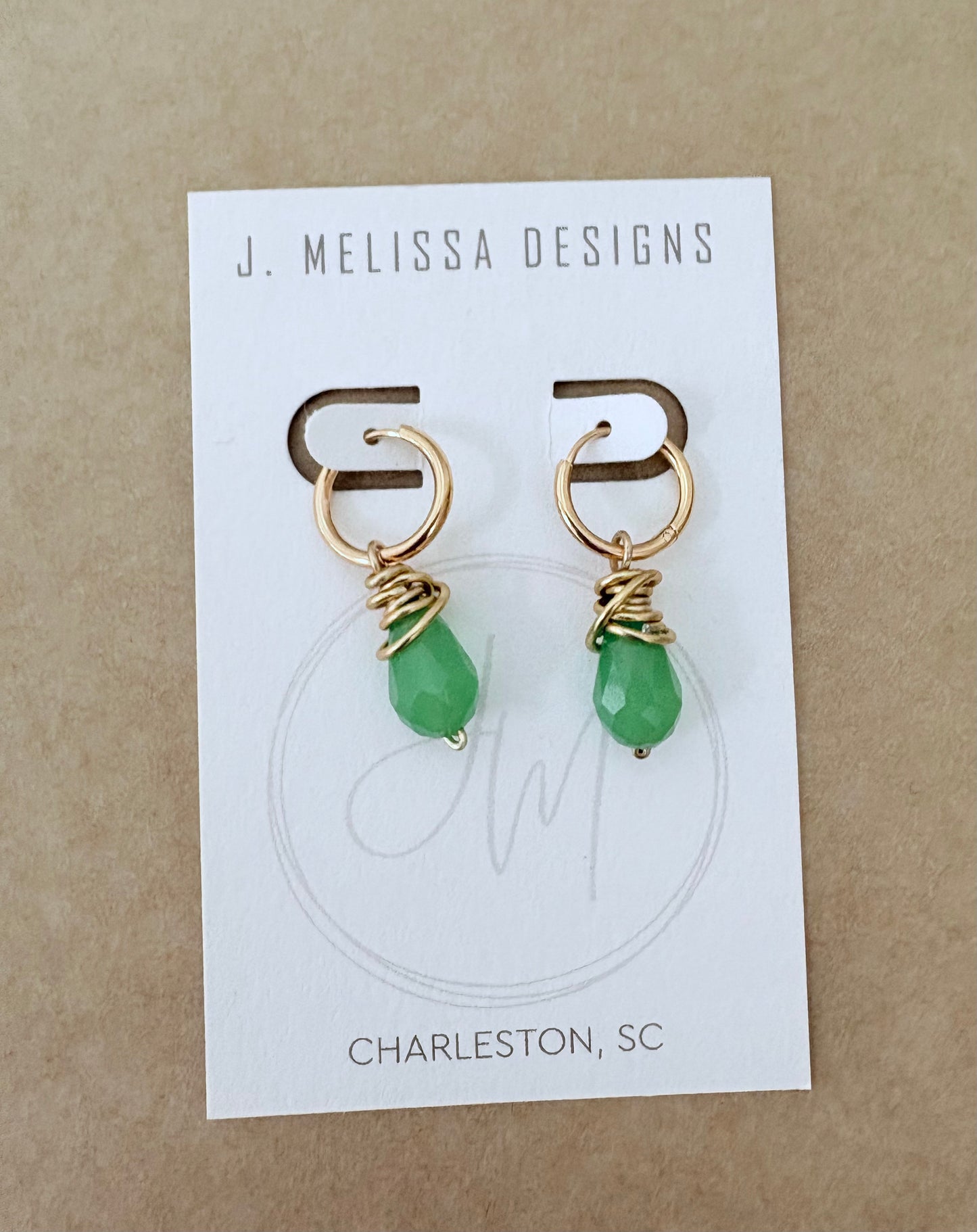 Gold earrings with green beads on a J. Melissa Designs card. ~ local Charleston jewelry